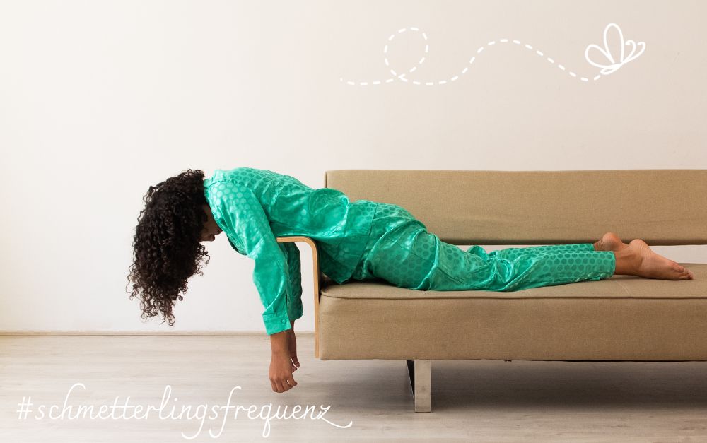 Geld hat keine Gefuehle, Menschen schon Eine Frau liegt bäuchlings auf einem Sofa. Ihr Oberkörper hängt über die Lehne.